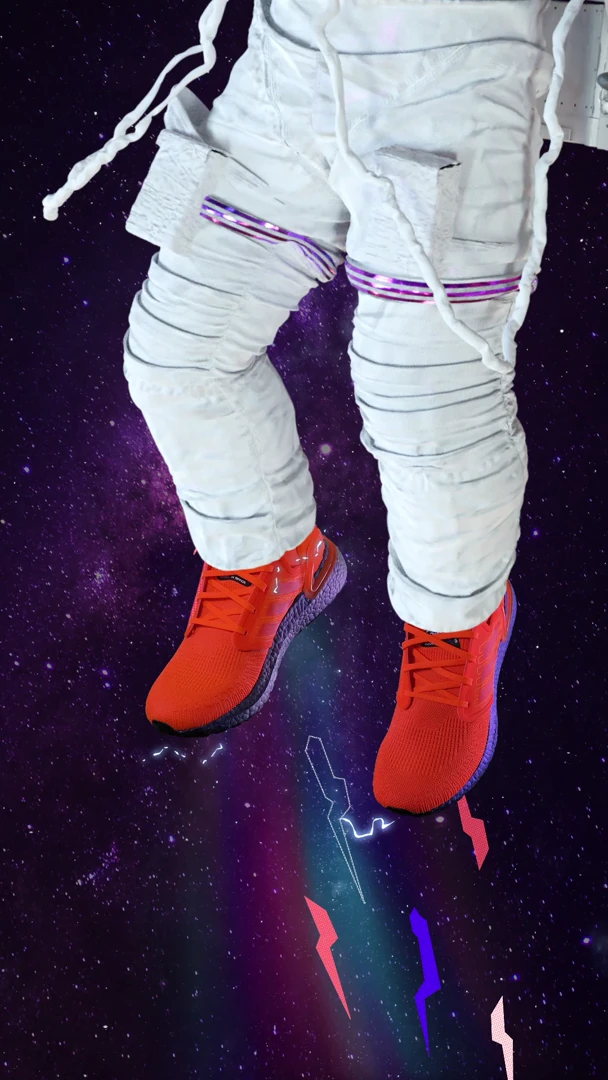 Close view of orange Adidas shoes worn by an astronaut against a violet star field