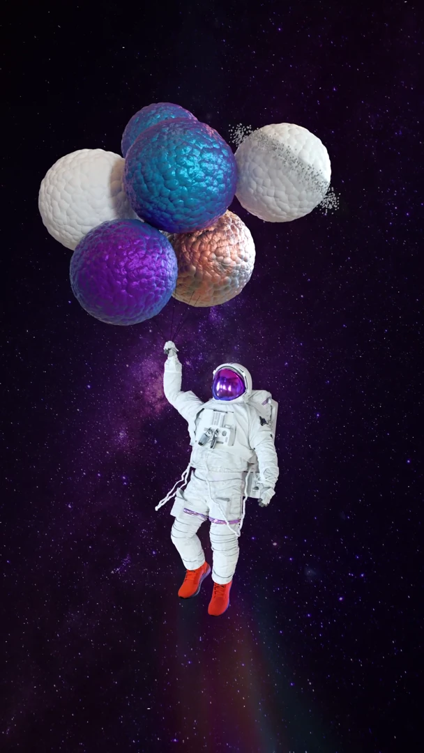 Astronaut in orange Adidas shoes floating below a cluster of colored soft spheres